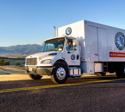 Large white Rogue Shred truck driving on the freeway